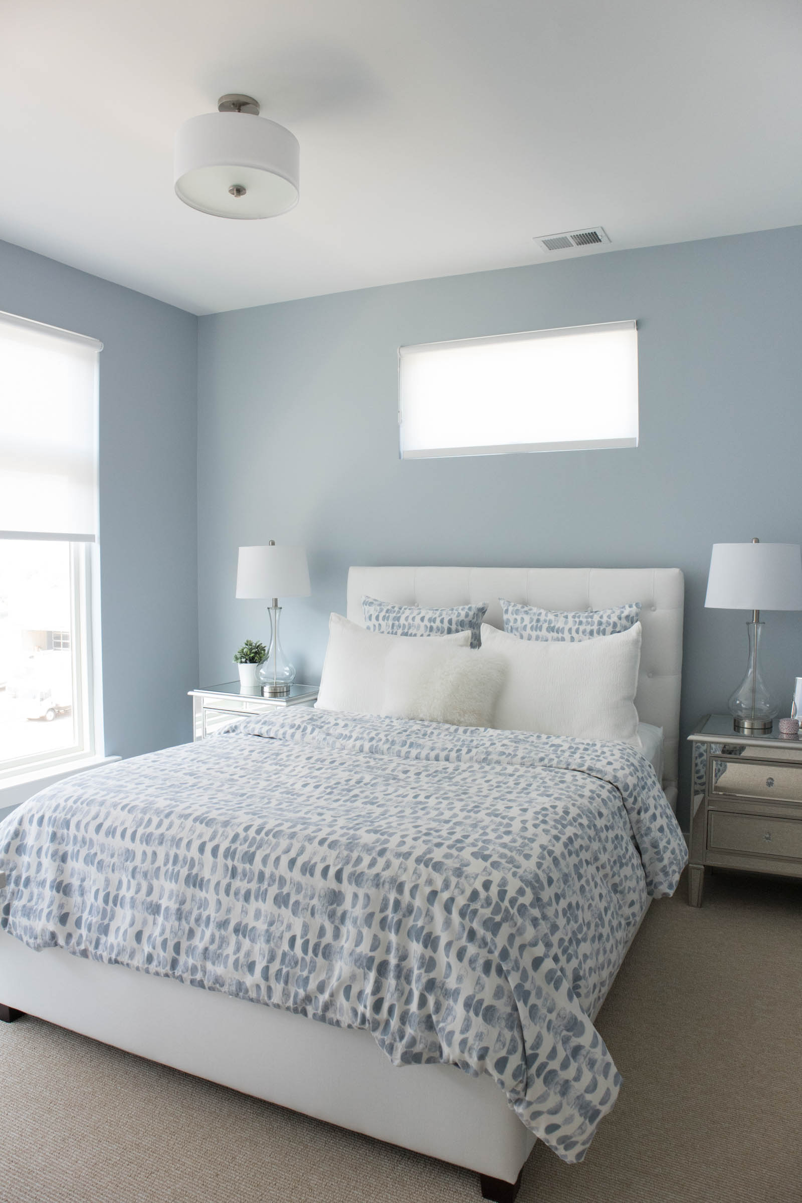blue guest bedroom, white tufted bed